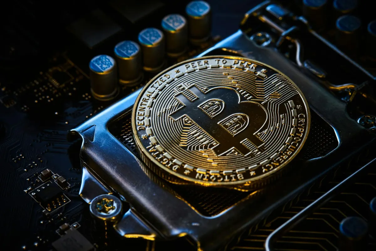A physical Bitcoin resting on a computer motherboard, crypto jobs versus web3 jobs