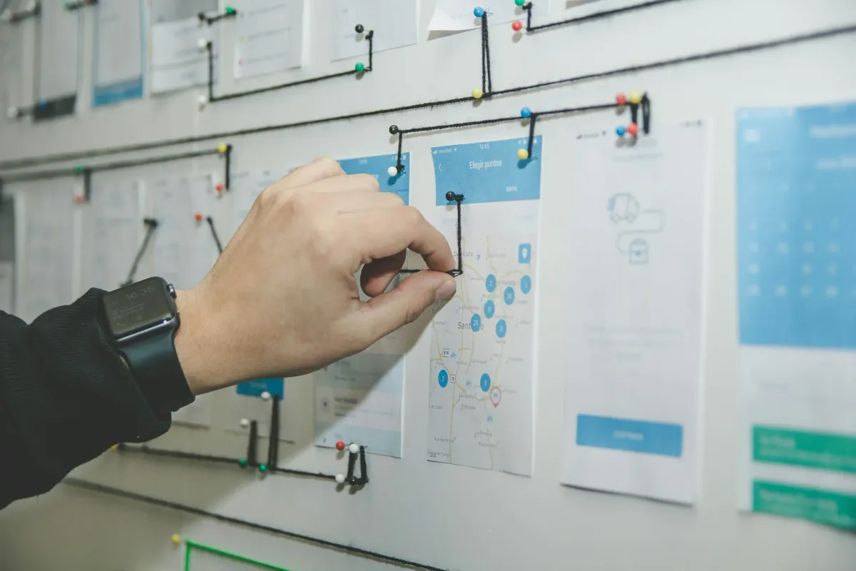 Hand pinning task cards to a project planning board
