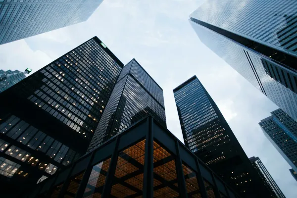 Looking up at glass corporate skyscrapers against the sky