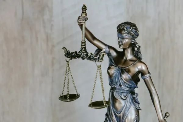 Bronze Lady Justice statue holding balanced scales