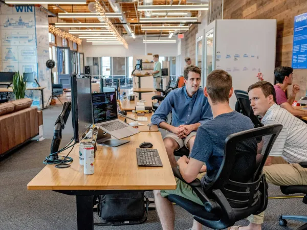 A team collaborating at an office desk, breaking into web3 jobs with no experience