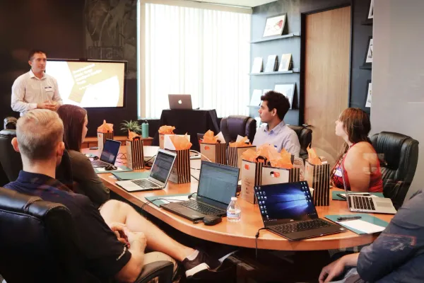 A speaker presenting to a seated audience with laptops, a complete guide to web3 jobs