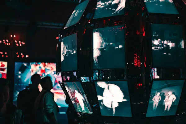 People gathered before a wall of glowing screens, weighing whether web3 is a good career