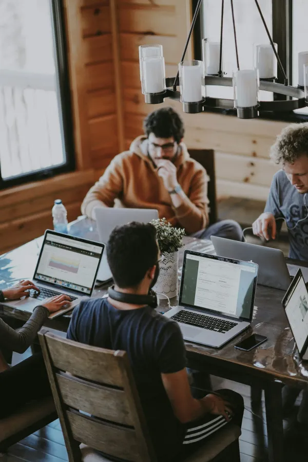 Developers working side by side on laptops, engineering blockchain protocols