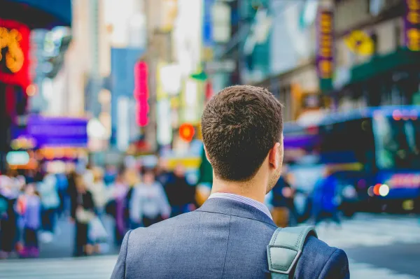 A person in a suit on a busy city street, pursuing non-technical web3 careers