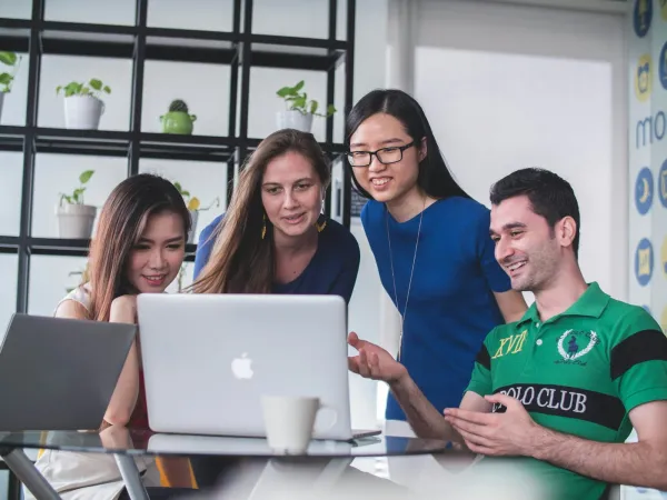 Four colleagues around a laptop, landing a first web3 internship