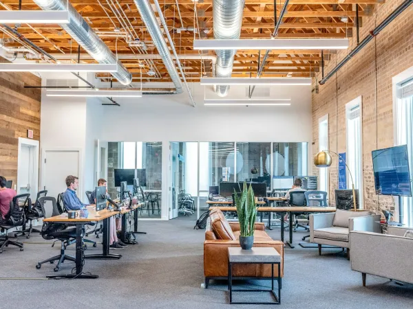 A professional working at a multi-monitor desk, closing web3 sales and BD deals