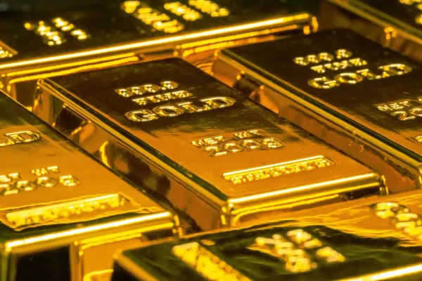 Rows of stacked gold bullion bars catching the light